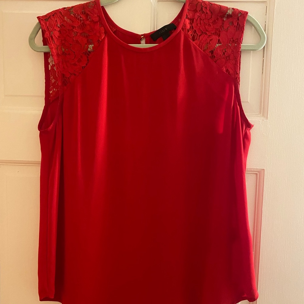JCrew red top with lace sleeves. Double gold button closure on back.